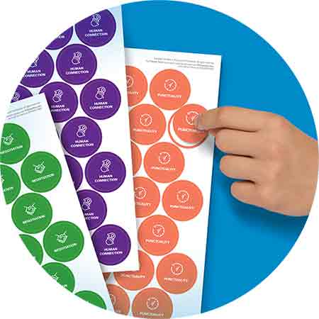 child's hand peeling sticker from sheet